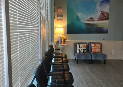 Cibola Dental patient waiting room with seating and ocean artwork